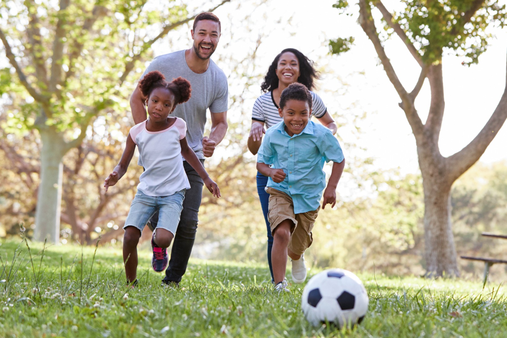 Family having fun and playing soccer